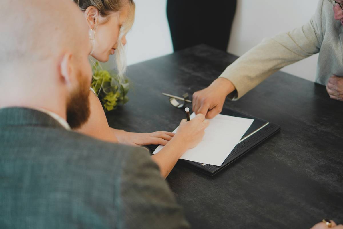 family legacy wealth transfer illustrated through generations signing documents around a table