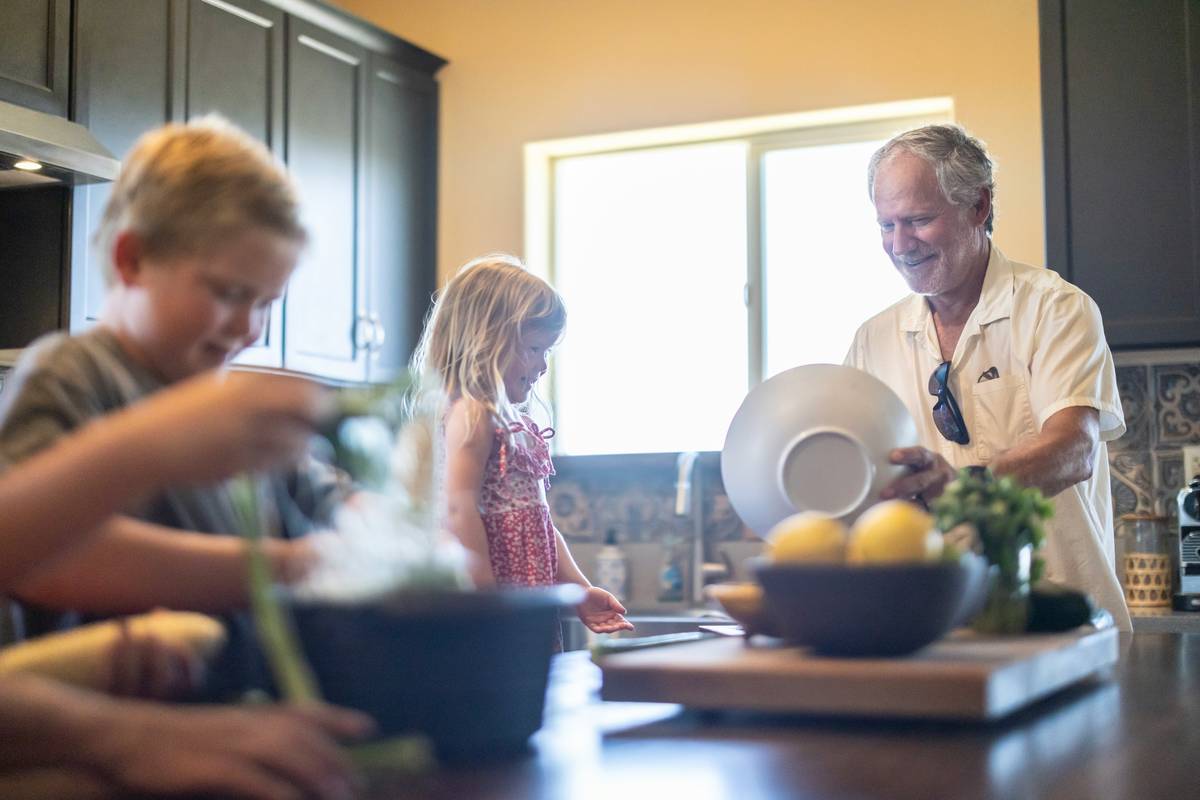 Family discussing intergenerational wealth transfer canada around a kitchen table with financial documents
